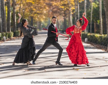 Man With Two Female Flamenco Dancers Dancing On A Park