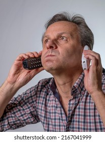 A Man With Two Phones Is Fed Up With Being Harassed Over The Phone With Unwanted Business Proposals