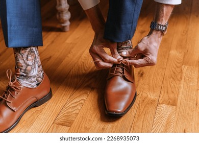 Man tying dress shoes for wedding day