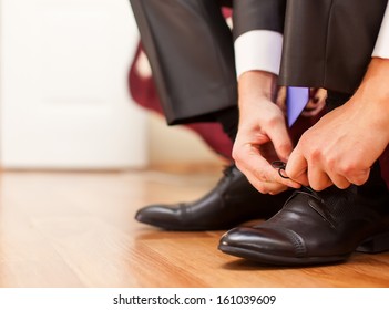 Man Is Tying His Black Shoes. Close-up