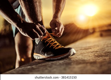 Man Tying Jogging Shoes