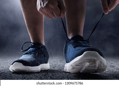 Man Tying Running Shoes