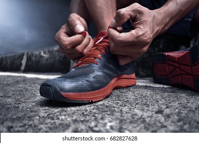 Man tying running shoes - Powered by Shutterstock