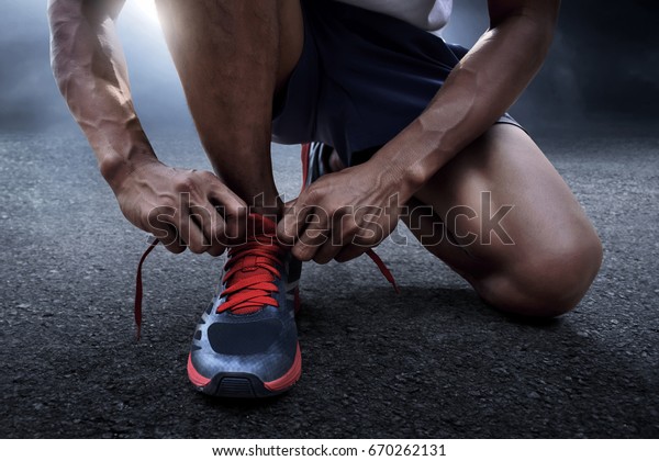 Man tying running\
shoes