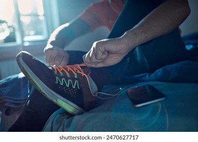 Man tying running shoes before workout