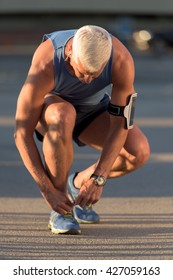 Man Tying Running Shoes Laces  Before Jogging Workout