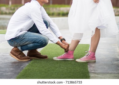 The Man Is Tying Shoelaces To His Lover.