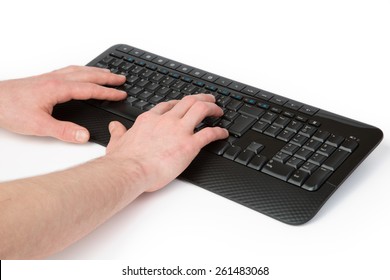 A Man Is Typing With Both Hands On A Black Keyboard.