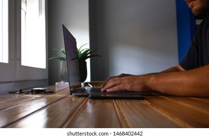 Man typing in grey computer