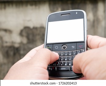 A man typing message on mobile phone with qwerty keyboard. Cellphones with blank display. - Shutterstock ID 1726202413