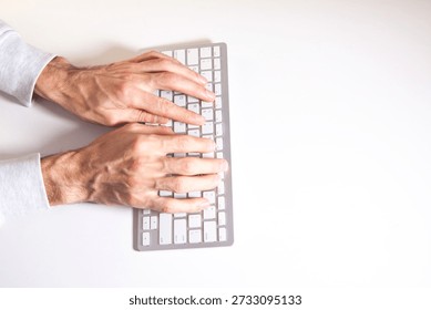 man typing on a computer keyboard.