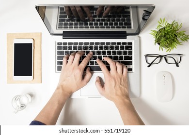 Man Is Typing On His Laptop. Top View, Flat Lay.