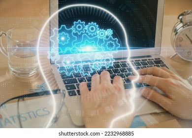 Man typing on keyboard background with brain hologram. Concept of big Data. - Shutterstock ID 2232968885