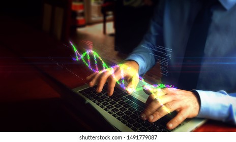 Man typing on laptop with biotechnology and DNA helix hologram screen over keyboard. Bioinformatics, science, biology, chemistry and research concept. Hand camera shake.