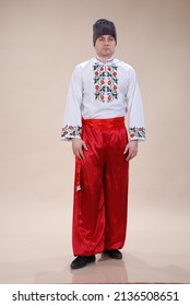 A man in Ukrainian folk costume on a white background. Man in bloomers, folk shirt - Shutterstock ID 2136508651