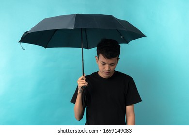 A Man With An Umbrella With A Sad Face