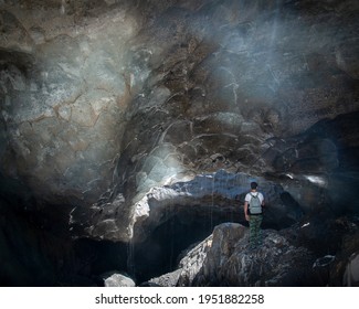 A Man Under A Textured Dome Of Light Ice, Ice Inside The Alibeksky Glacier In Dombai