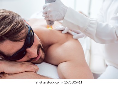 Man Under Treatment In A Hair Removal Studio