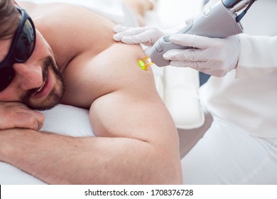 Man Under Treatment In A Hair Removal Studio