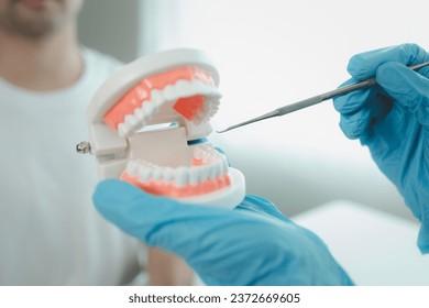 Man undergoes a dental checkup with professional dentist at dental clinic, undergoes a dental checkup with a professional dentist and receives oral care advice. Concept of receiving dental treatment. - Powered by Shutterstock