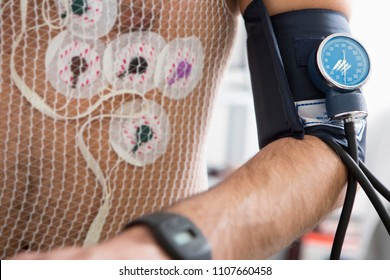 Man Undergoing Electrocardiogram And Pressure Measurement