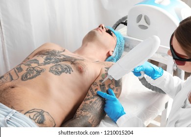 Man Undergoing Laser Tattoo Removal Procedure In Salon