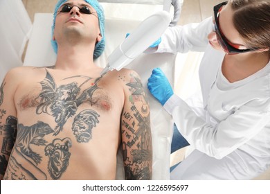 Man Undergoing Laser Tattoo Removal Procedure In Salon