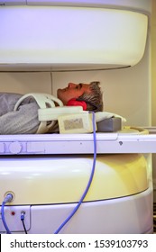 Man Undergoing Open MRI Scan At Hospital.