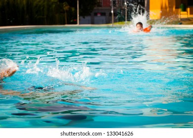 Man Underwater In A Swimming Pool While A Lifeguard Swim To Rescue Him