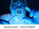 Man in uniform holds microprocessor with forceps. Repair microprocessor electronics electrical equipment. Dust protection at enterprise for creation electronic devices. Chemical elements in design