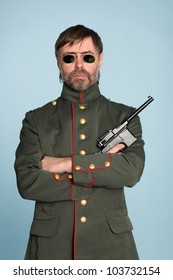 Man In The Uniform Of A Military Officer With A Gun.