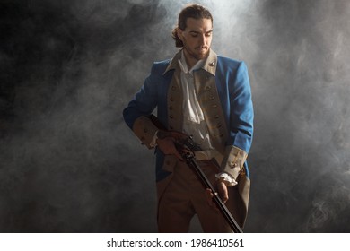 Man In Uniform Of An Officer Of Patriots Of Revolutionary War With Musket. Historical Concept Of 4th Of July USA