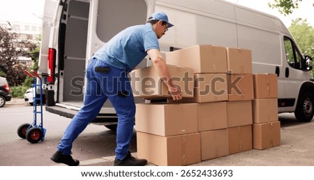 Man Unloading Boxes From Van For Removal And Delivery Service.