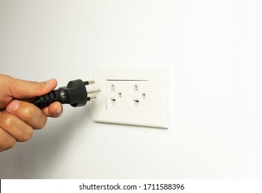 Man Unplug Power Cable Cord From Socket