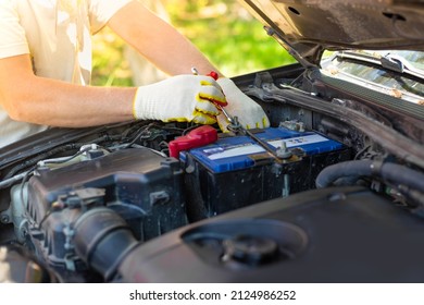 A Man Unscrews A Car Battery Mount. Battery Repair And Replacement.