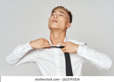 A Man Untie A Tie On His Neck And A White Shirt