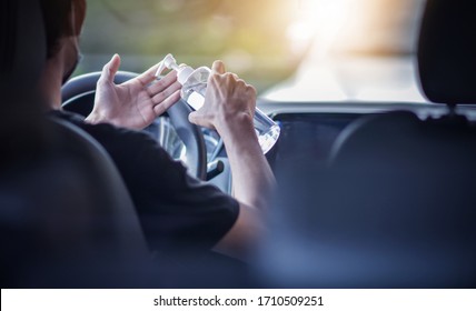 Man Use Alcohol Gel 70% Cleaning Hand In Car To Protect Corona Virus 2019 Or Covid 19