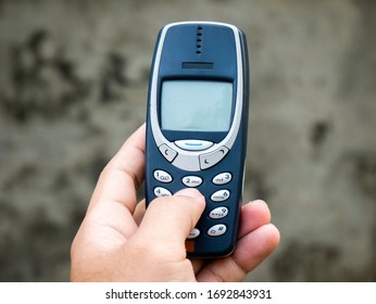 A man use Cell Phone. 2g GSM Mobile phone on hand. - Shutterstock ID 1692843931