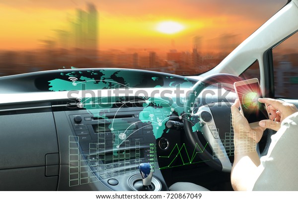 man use cell-phone connect to\
intelligent car or  futuristic vehicle and graphical user interface\
connected car. Internet of Things. Heads up\
display(HUD).