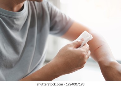 A man use medical cotton swab for cleaning and disinfection of wounds Cat scratch in First aid concept bleeding wounds 