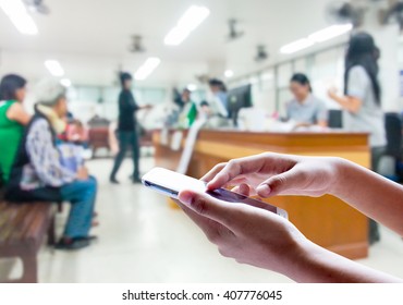 Man Use Mobile Phone, Blur Image Inside Hospital As Background.