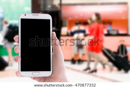 Man use mobile phone ,blur image of inside airport as background
