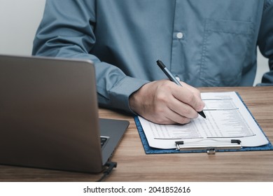 A Man Use A Pen White On Clip Board In Check Spare Part Check List Of Car In Service Center Office