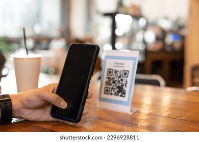 man use smartphone to scan QR code for order menu in cafe restaurant with a digital delivery. Choose menu and order accumulate discount. E wallet, technology, pay online, credit card, bank app.