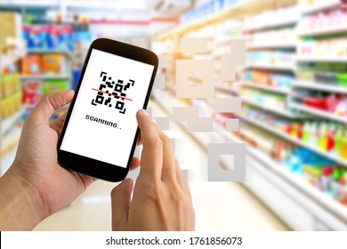 Man use smartphone scanning QR code for pay in supermarket. - Shutterstock ID 1761856073