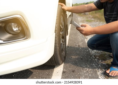The man used the phone to call for help when his car broke down. - Shutterstock ID 2154928391