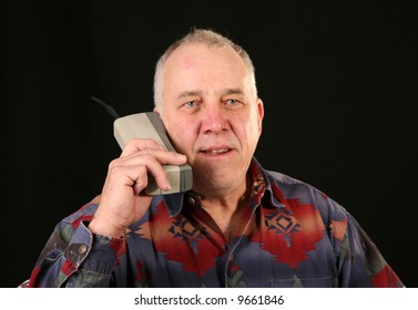 A Man Uses A 1980s Era Cellular Telephone Also Known As A 