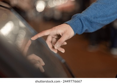 a man uses a digital terminal with a touchscreen, an electronic queue, Entertainment and technology concept - Powered by Shutterstock