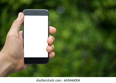 Man Uses His Mobile Phone Outdoor, Close Up, Capture The Moment By A Smart Phone In My Hands. Nature Background. Green Background.