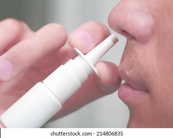 Man Uses A Nasal Spray 